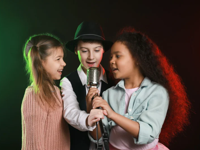 three youth singing harmoniously in a group