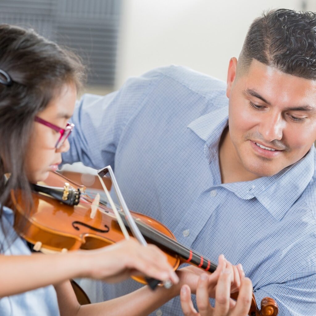 music teacher conducting a violin lesson