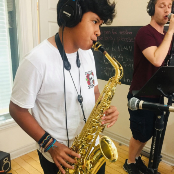 student playing the saxophone in a band during a lesson in Toronto