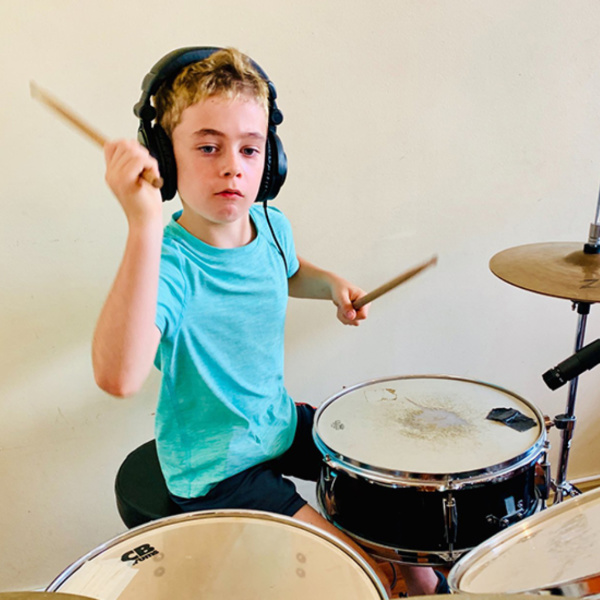 student playing the drums during a drum lesson in Toronto
