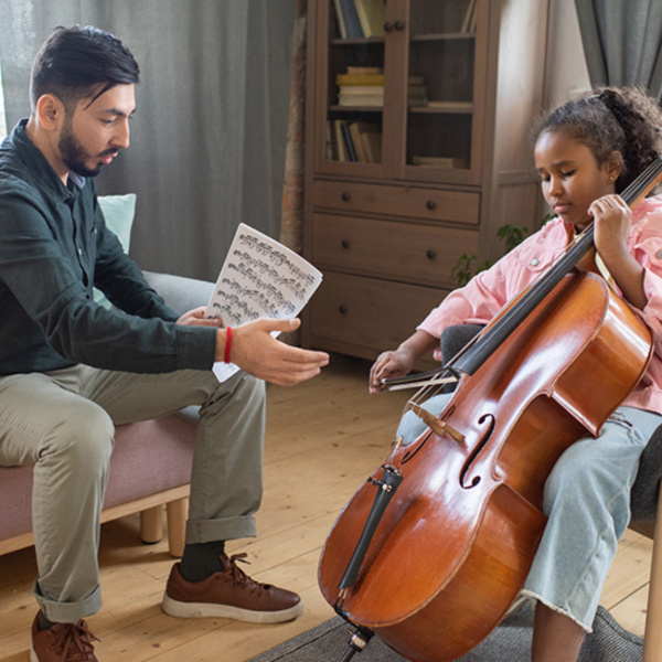 teacher teaching the student cello during a cello lesson in Toronto