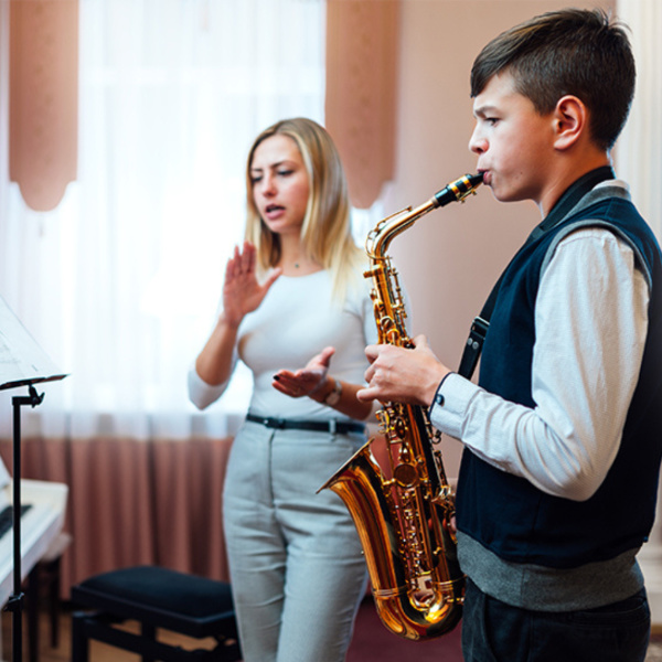 student playing the saxophone during a lesson with the teacher in Toronto