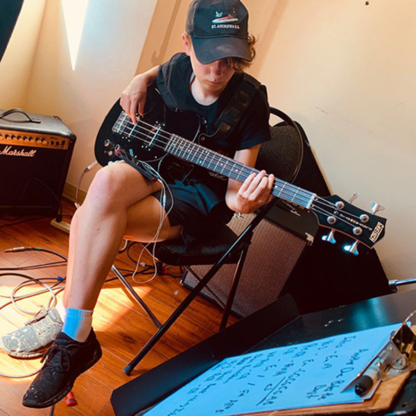 student playing the guitar during bass lessons in Toronto