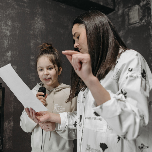 teacher teaching student how to sing during a singing lesson in Toronto