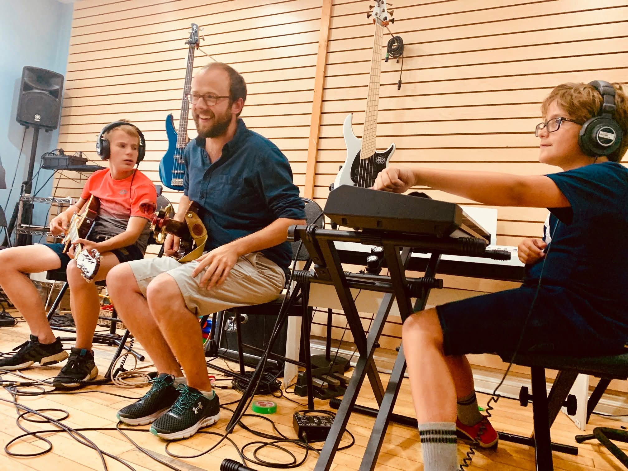 Students playing together in a band during group music lessons in Toronto at Elite Music Academy