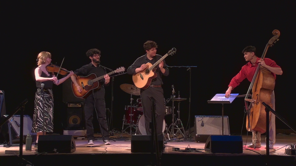 Callum C. performing guitar with a live ensemble in Toronto.