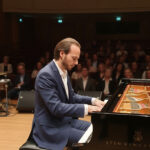 Pejman A., piano teacher in Toronto, performing at a grand piano