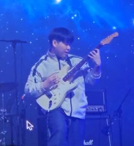Sangho L. playing electric guitar on stage – Guitar & Bass Lessons on the Danforth at Elite Music Academy.