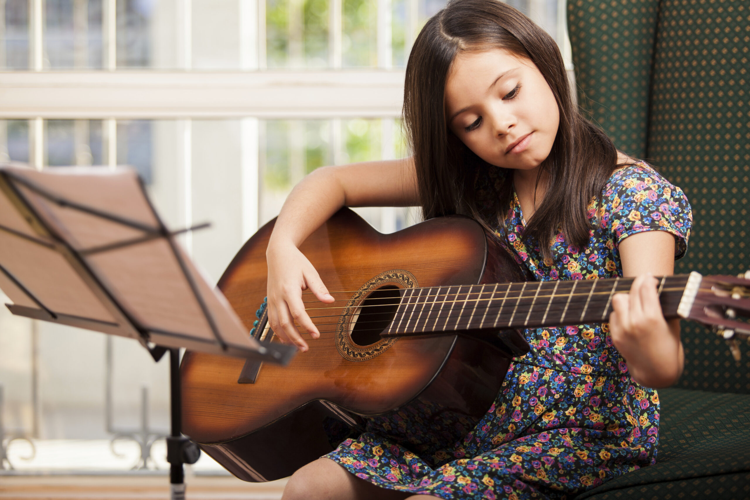 Little girl practices her music lesson at home in North York